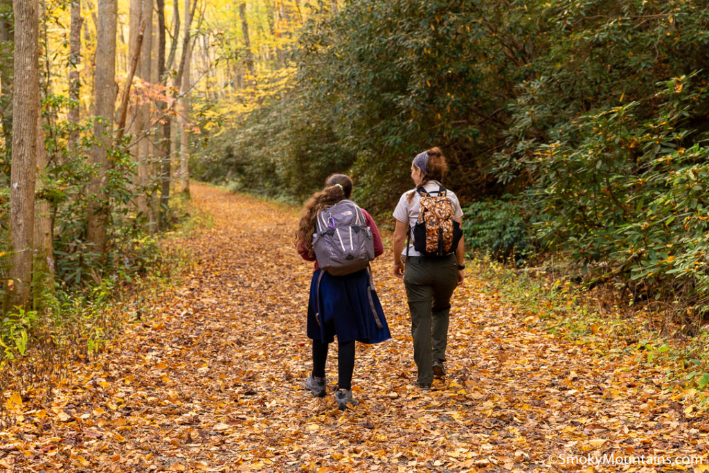 two women backpackers on trail in the fall